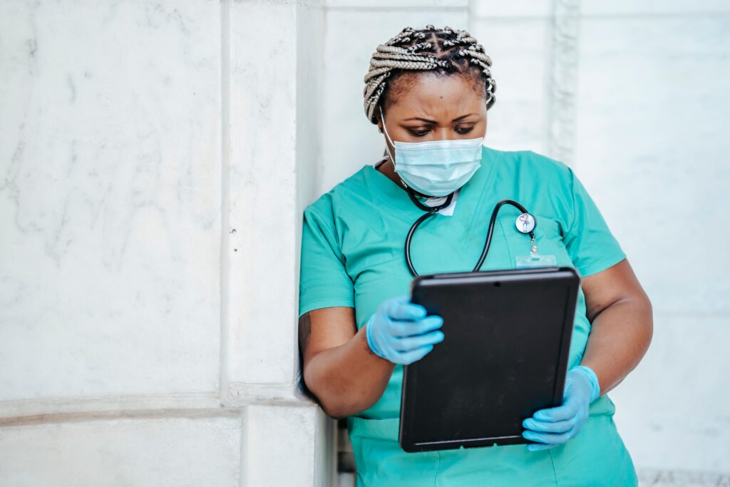 Nurse in scrubs closely reviewing patient documentation, the kind of focused, high-stakes decision moment that shows why scenario-based learning outperforms traditional training